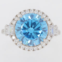 Round blue topaz ring in sterling silver with accent stones, showcasing sparkling elegance.