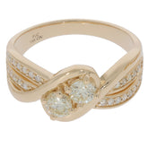 Elegant 14K yellow gold ring featuring round accent diamonds, showcasing intertwined design and sparkle.
