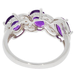 Sterling silver ring featuring multiple oval purple amethyst gemstones, showcasing intricate design and elegance.