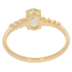 14K yellow gold ring featuring a green peridot gemstone with diamond accent, showcasing elegant craftsmanship.