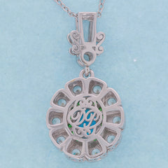 Elegant Oval Blue Opal Sterling Silver Pendant featuring intricate design and sparkling gemstone accents.