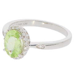 Green Peridot 14K White Gold Ring with Diamond Accent, featuring an oval cut gemstone and detailed band design.