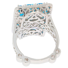 Back view of an elegant oval blue turquoise sterling silver ring with intricate cut-out design accents.
