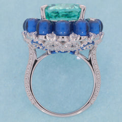 Cushion green Moissanite sterling silver ring with blue accents, showcasing elegant gemstone craftsmanship.