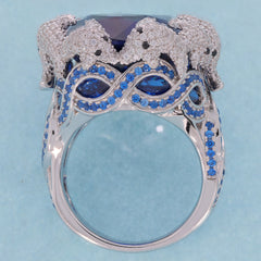 Oval blue sapphire sterling silver ring featuring elephant accents and intricate blue stone details.