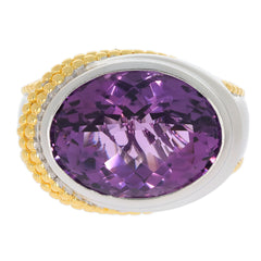 Oval purple amethyst sterling silver ring with gold accents, showcasing a sparkling gemstone in an elegant design.