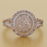 Rose gold sterling silver ring with sparkling diamond accent in a circular design, showcasing timeless elegance.