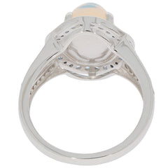 Detail view of an Oval White Opal Sterling Silver Ring showcasing the silver band and opal gemstone on top.