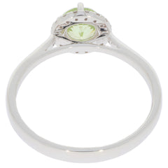 Elegant Green Peridot Sterling Silver Ring with Moissanite Accent, showcasing intricate design and a sparkling gemstone.