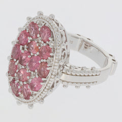 Elegant pink sapphire sterling silver ring with multiple gemstones, showcasing luxury and sophistication.