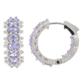 Elegant oval purple sapphire sterling silver earrings, featuring sparkling gemstones and a chic hoop design.