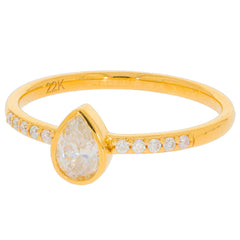 Pear cut white diamond ring in 22K gold setting with accent stones, showcasing elegance and luxury.
