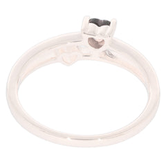 Heart-shaped setting of a red garnet in a sleek sterling silver ring, showcasing elegant craftsmanship.