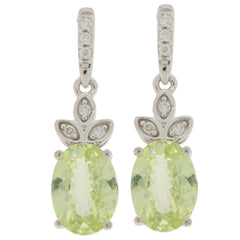 Oval green peridot earrings set in 14K white gold with diamond accents, showcasing elegant design and sparkle.