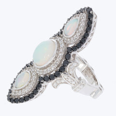 Elegant sterling silver ring featuring three oval opals and black spinel accents, radiating luxury and sophistication.
