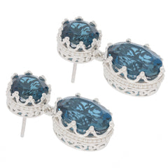 Oval blue London Topaz earrings in sterling silver with intricate design, perfect for elegant occasions.