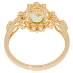 Oval green peridot 14K yellow gold ring with diamond accents, showcasing intricate design and luxurious appeal.