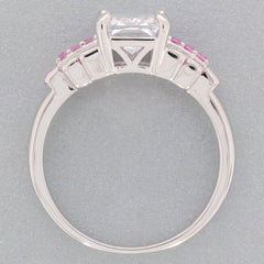 Emerald white moissanite sterling silver ring with pink accent gemstones, showcasing elegance and luxury.