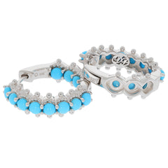 Elegant round blue turquoise sterling silver earrings with sparkling accents, perfect for sophisticated style.