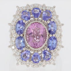 Oval pink topaz sterling silver ring surrounded by shimmering purple stones, radiating elegance and luxury.