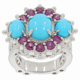 Oval blue turquoise ring with purple accent stones in sterling silver setting, showcasing vibrant elegance.