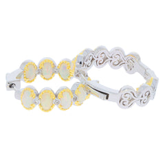 Elegant sterling silver jewelry set featuring oval opal gemstones and diamond accents in yellow gold settings.