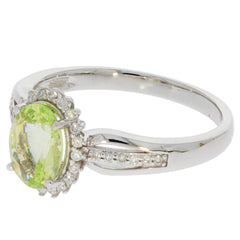 14K white gold ring featuring a vibrant green peridot gemstone and sparkling diamond accents.