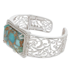 Elegant blue turquoise sterling silver bangle with intricate detailing and sparkling gemstone accents.