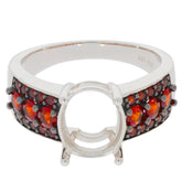 Oval red garnet sterling silver ring with accent gemstones, showcasing elegant design and luxury style.
