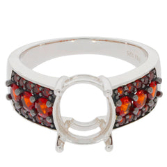 Oval red garnet sterling silver ring with accent gemstones, showcasing elegant design and luxury style.