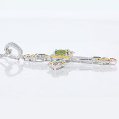 Elegant Green Peridot sterling silver pendant with Topaz accent, showcasing luxury and sophistication in jewelry design.