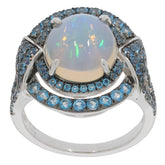 Oval white opal sterling silver ring with blue gemstone accents, radiating elegance and luxury.