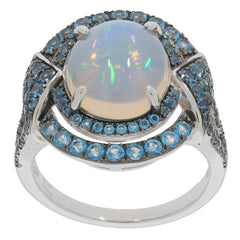 Oval white opal sterling silver ring with blue gemstone accents, radiating elegance and luxury.