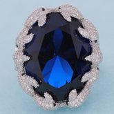 Elegant Oval Blue Sapphire Sterling Silver Ring with dazzling accents, showcasing a rich blue gemstone in a stunning design.