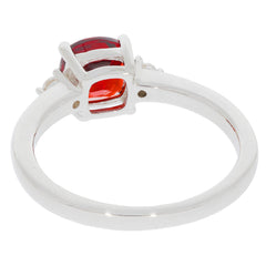 Cushion red garnet sterling silver ring showcasing a moissanite accent from the side view.