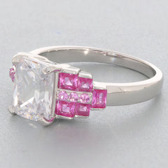Emerald white moissanite ring in sterling silver with pink accents, showcasing elegance and luxury.
