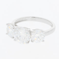 Round white moissanite sterling silver ring featuring three sparkling gemstones, radiating elegance and luxury.