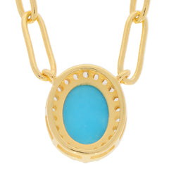 Blue turquoise gemstone set in gold necklace, featuring an elegant oval cut and sparkling design.