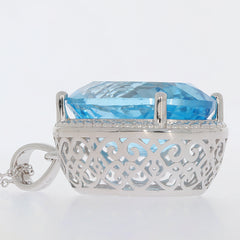 Oval blue topaz sterling silver pendant showcasing intricate design and sparkling gemstone elegance.