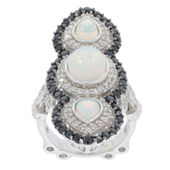Elegant silver ring featuring three oval white opals surrounded by sparkling black accents and intricate detailing.