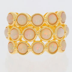 Elegant gold ring featuring multiple white opal gemstones in a stylish stacked design.