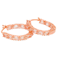 Rose gold hoop earrings featuring sparkling white gemstones in a beautiful design.