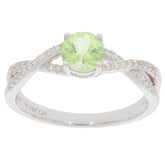 Green Peridot ring in 14K white gold with diamond accents, perfect for elegant style and luxury.