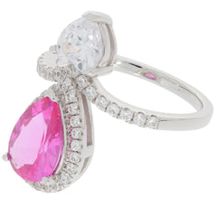 Pink sapphire sterling silver ring with moissanite accent, featuring a pear-cut pink gemstone and sparkling details.