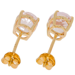 Round pink sapphire earrings in 14K yellow gold setting, showcasing elegant design and sparkling gemstone.