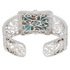 Blue turquoise sterling silver bangle featuring intricate filigree design and sparkling gemstone accent.