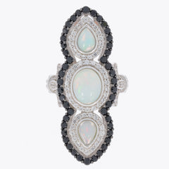 Elegant oval white opal and black spinel ring in sterling silver, showcasing intricate gemstone arrangement.