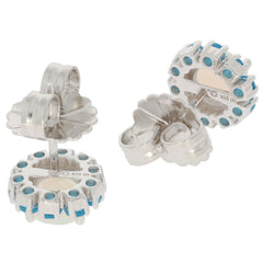 Round white opal sterling silver earrings with blue accents, showcasing intricate design and shimmering gemstones.