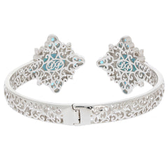 Sterling silver cuff bracelet featuring intricate filigree design and turquoise accents, elegant jewelry piece.