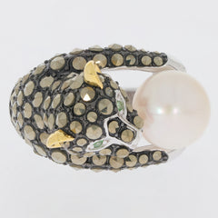 Intricate panther-shaped ring featuring black diamonds and a large pearl accent, elegantly designed in silver and gold.